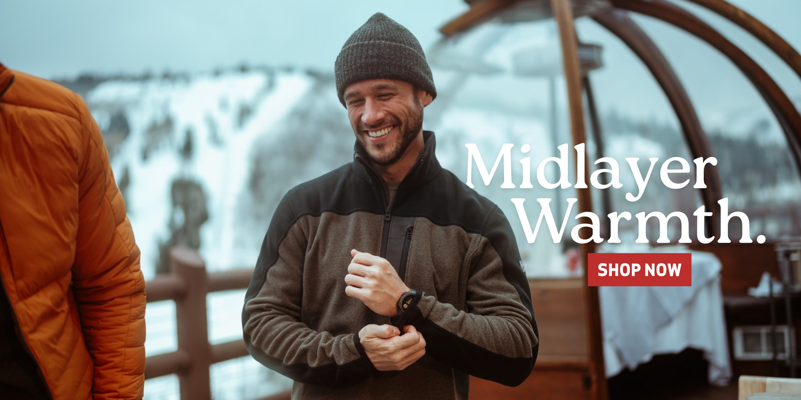 Man wearing Kuhl 1/4 zip fleece pullover in wintery environment. "Midlayer warmth - Shop now"