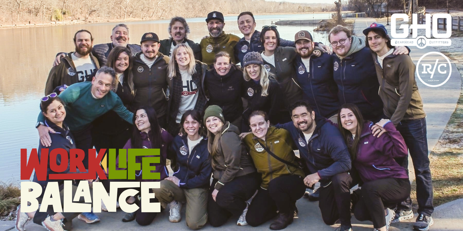 Work Life Balance group photo of employees in front of a river